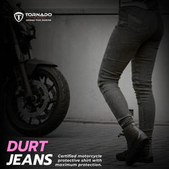 Person wearing Durt jeans next to a motorcycle with Tornado branding.